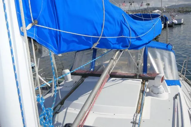 Slide: The Image of 1991 Catalina 36 sailboat with blue sail cover docked in marina. - 43