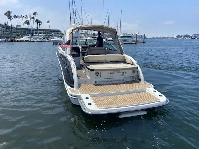 Slide: The Image of 2017 Formula 350 Sun Sport boat cruising in a marina. - 3