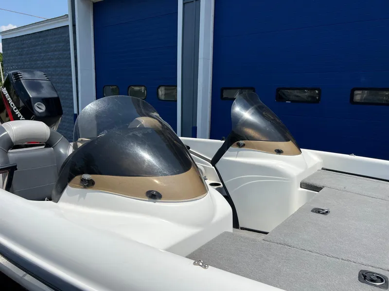 Slide: The Image of 2000 Triton TR170C boat with dual windshields and Mercury outboard motor. - 11