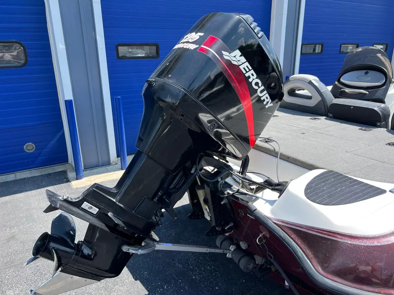 Slide: The Image of Triton TR170C 2000 boat with Mercury outboard motor in a marina. - 13