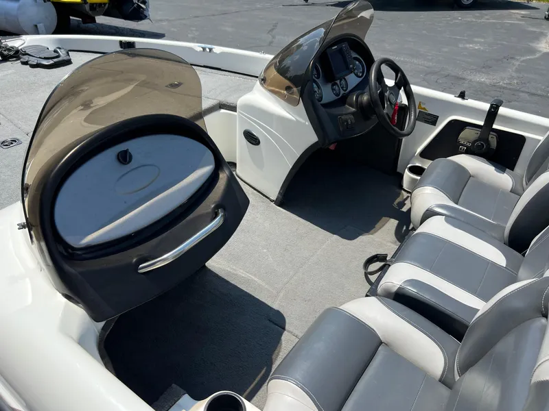 Slide: The Image of 2000 Triton TR170C boat interior with steering console and seating. - 17