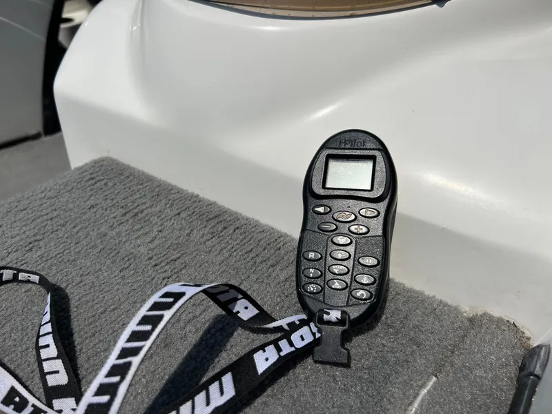 Slide: The Image of Remote control on a 2000 Triton TR170C boat deck. - 22