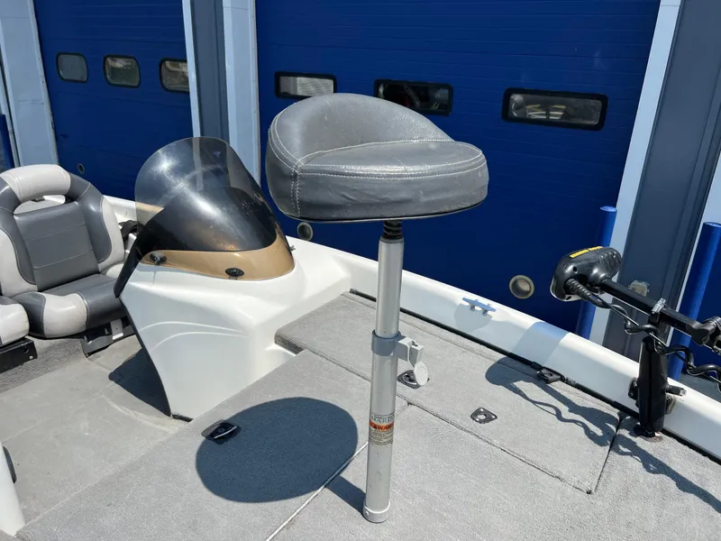 Slide: The Image of 2000 Triton TR170C boat interior with seating and control console. - 23