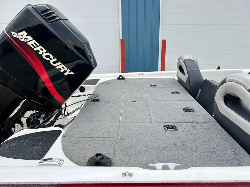Slide: The Image of Triton TR170C 2000 boat with Mercury outboard motor, spacious deck, and comfortable seating. - 3