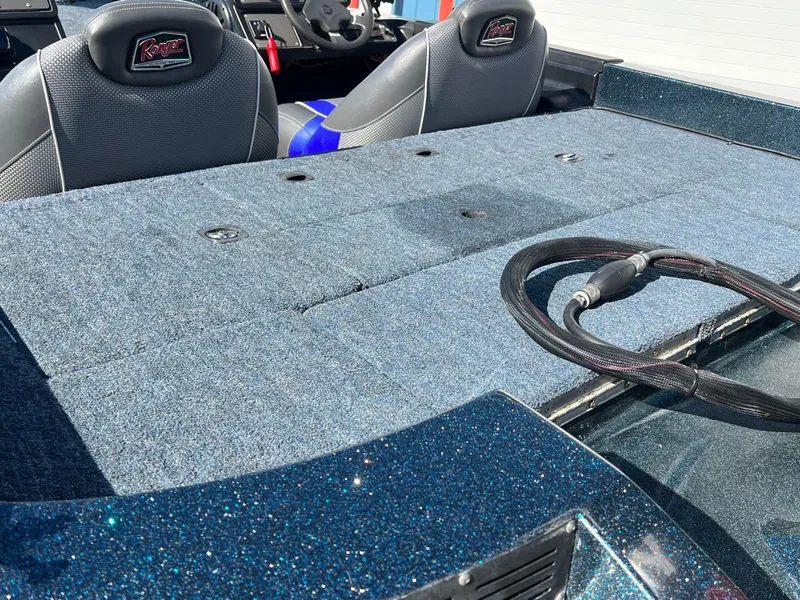 Slide: The Image of 2000 Triton TR170C boat interior with carpeted deck and seats. - 6