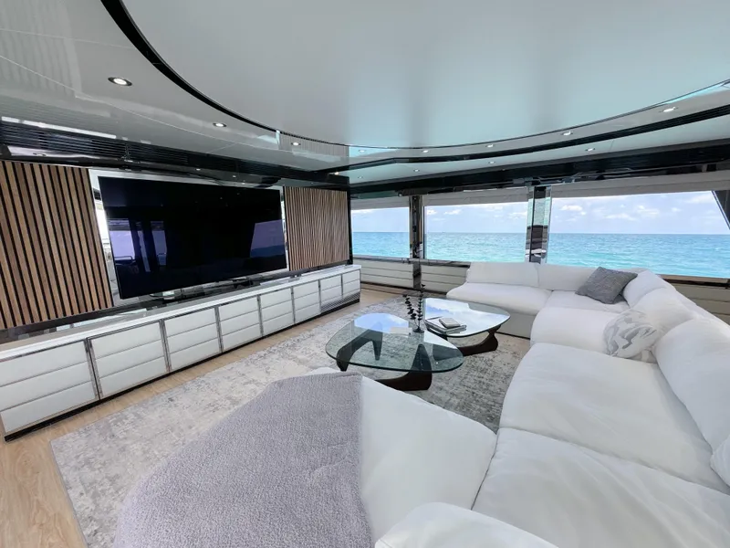 Slide: The Image of Luxurious yacht interior with white sectional sofa, large TV, and ocean view, Custom WHS Marine 2010. - 13
