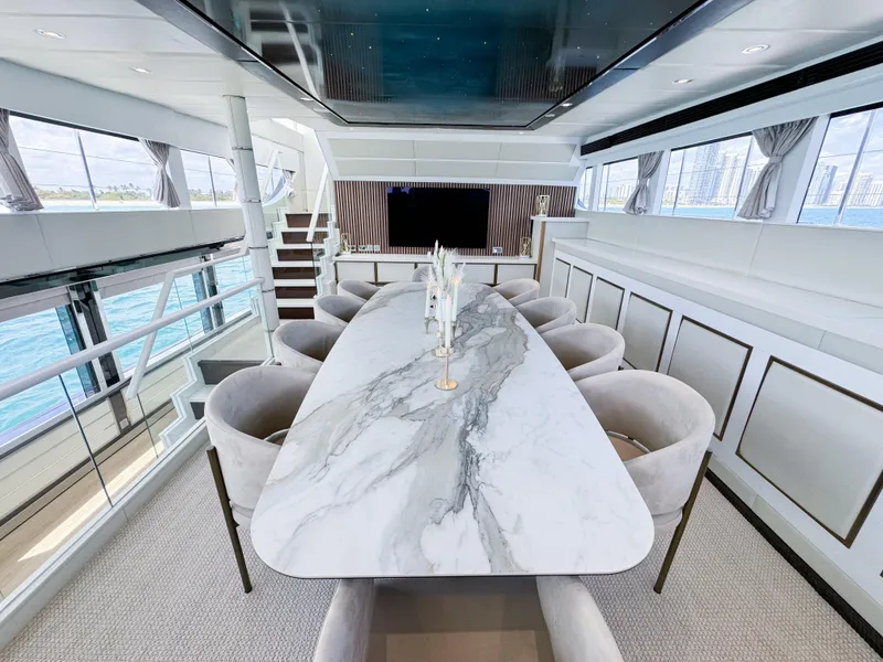 Slide: The Image of Luxurious dining area on a 2010 Custom WHS Marine yacht with marble table and panoramic windows. - 21