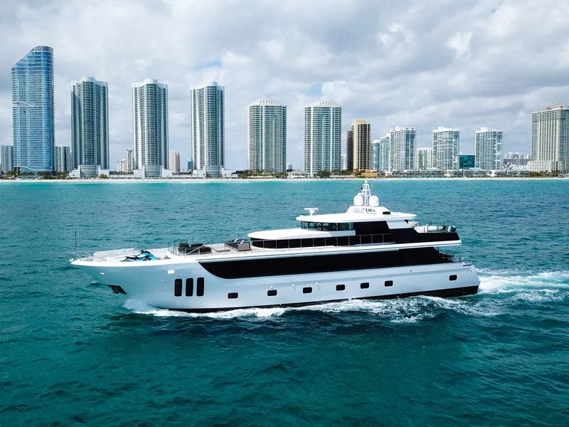 Slide: The Image of Custom WHS Marine 2010 yacht cruising near a city skyline with tall buildings. - 3