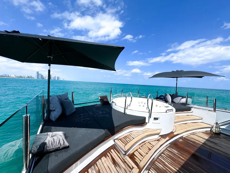 Slide: The Image of Luxury yacht deck with sun loungers, hot tub, and umbrellas on a sunny day. - 30