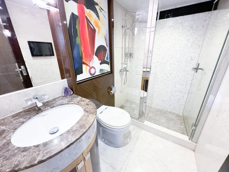 Slide: The Image of Luxurious yacht bathroom with modern fixtures, marble countertop, and glass shower enclosure. - 38