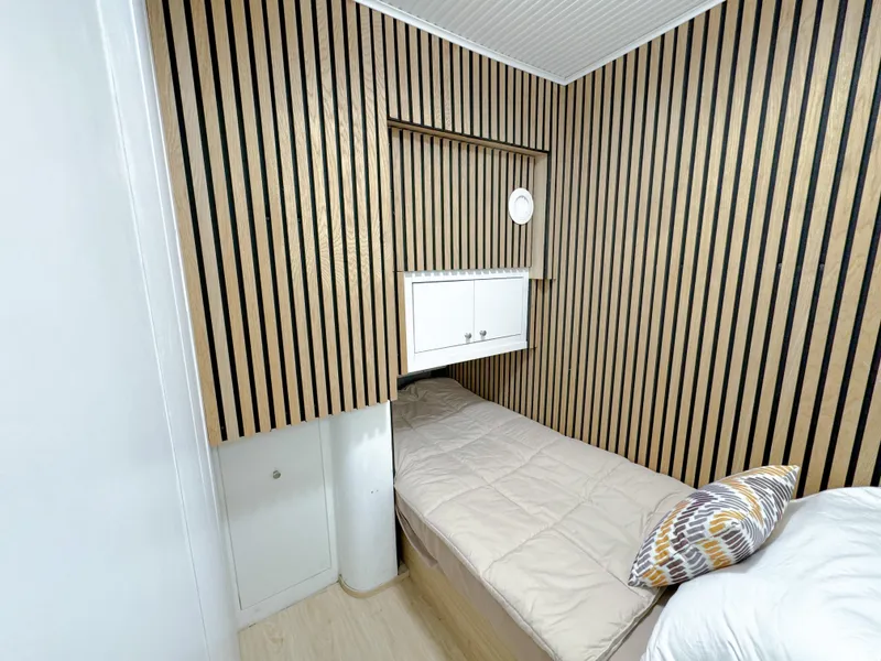 Slide: The Image of Small cozy cabin bed in 2010 WHS Marine custom boat with modern wood paneling. - 46