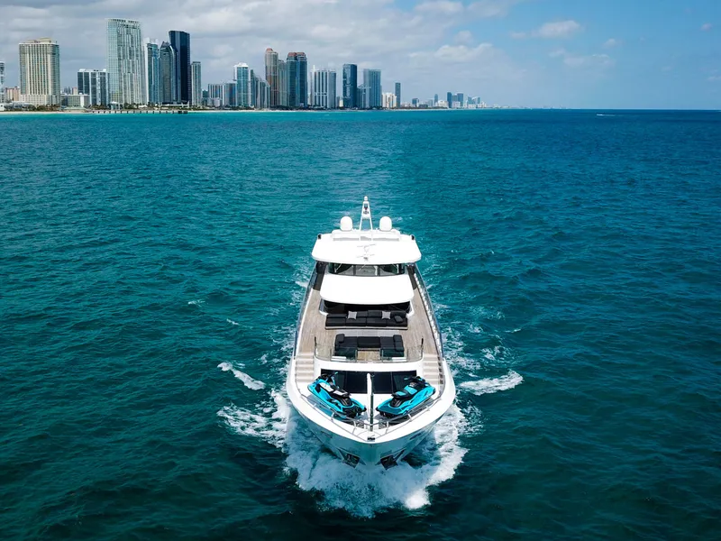 Slide: The Image of Custom WHS Marine 2010 yacht cruising near a city skyline on a sunny day. - 48