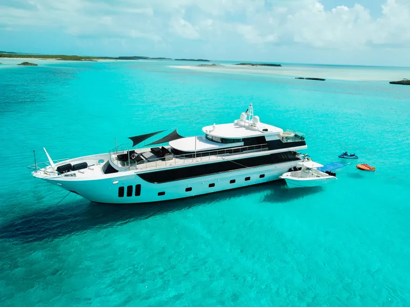 Slide: The Image of Luxurious 2010 Custom WHS Marine yacht in turquoise waters, surrounded by jet skis. - 7