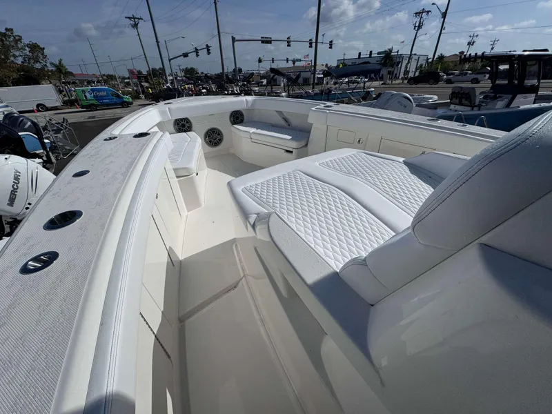 Slide: The Image of 2024 Solace 37 CS boat interior with white seating and Mercury engines. - 10