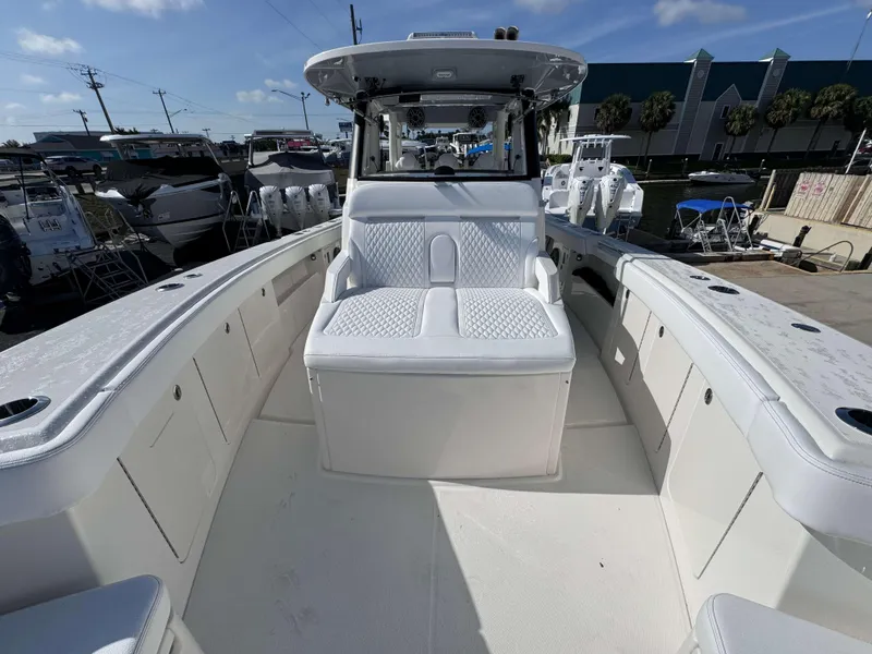 Slide: The Image of 2024 Solace 37 CS boat interior with white seating and storage compartments. - 11