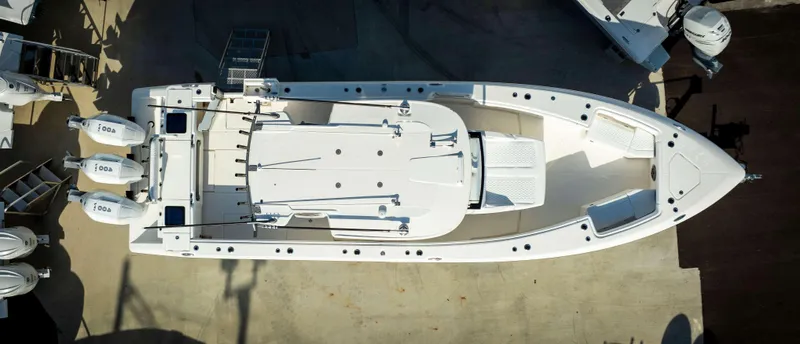 Slide: The Image of Aerial view of 2024 Solace 37 CS boat with triple outboard engines. - 13