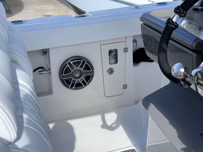 Slide: The Image of Interior of 2024 Solace 37 CS boat featuring speaker and storage compartment. - 19