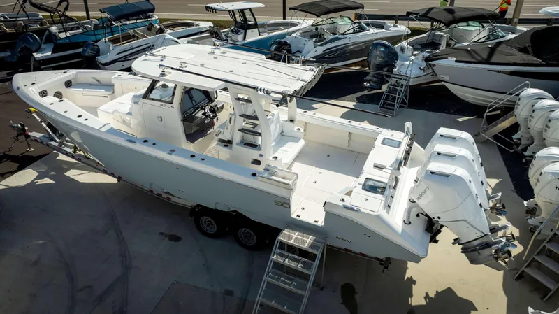 Slide: The Image of 2024 Solace 37 CS boat with triple Mercury outboard engines on display. - 2