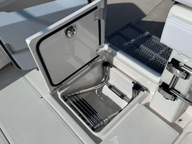 Slide: The Image of 2024 Solace 37 CS boat with open storage compartment and retractable ladder. - 25
