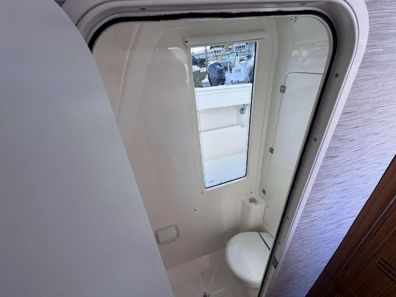 Slide: The Image of 2024 Solace 37 CS boat bathroom with toilet and window. - 27