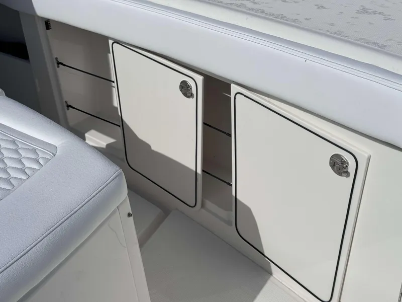 Slide: The Image of 2024 Solace 37 CS boat interior storage compartments and cushioned seating. - 29