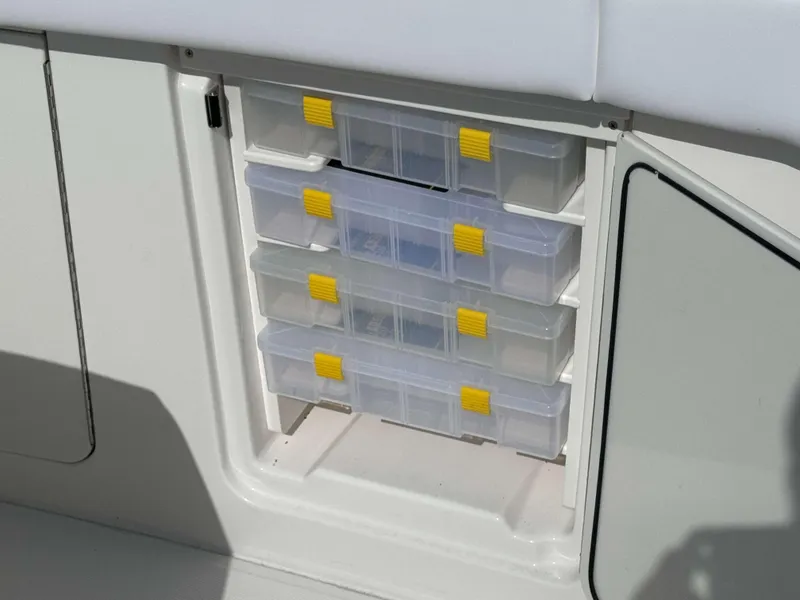 Slide: The Image of Storage compartment with plastic drawers on a 2024 Solace 37 CS boat. - 30