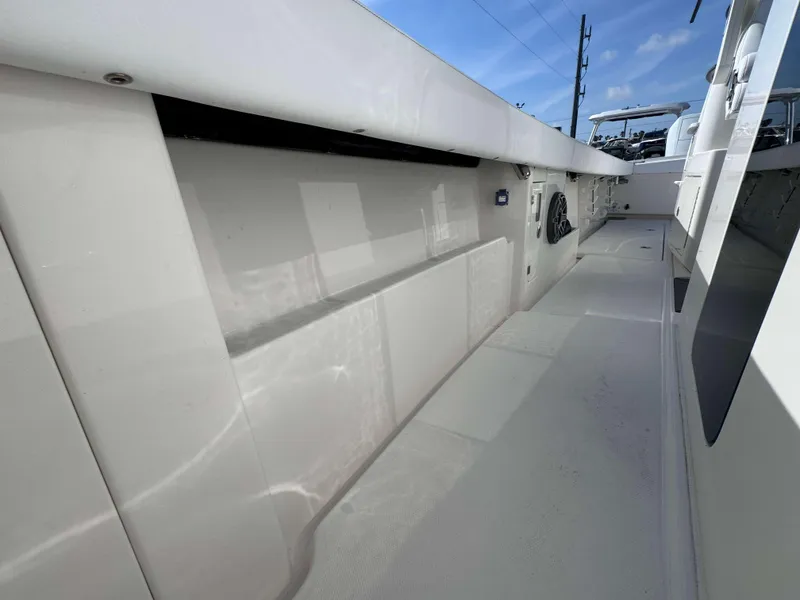 Slide: The Image of 2024 Solace 37 CS boat deck with storage compartments and clean white finish. - 33