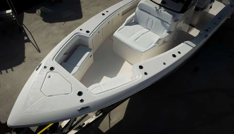 Slide: The Image of 2024 Solace 37 CS boat interior with white cushioned seating and storage compartments. - 37