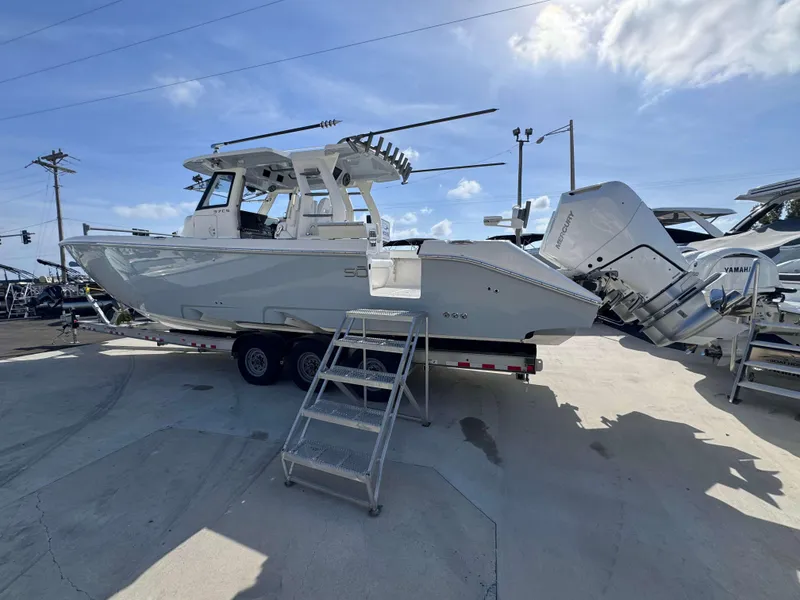 Slide: The Image of 2024 Solace 37 CS boat on trailer with dual Mercury outboard engines. - 38