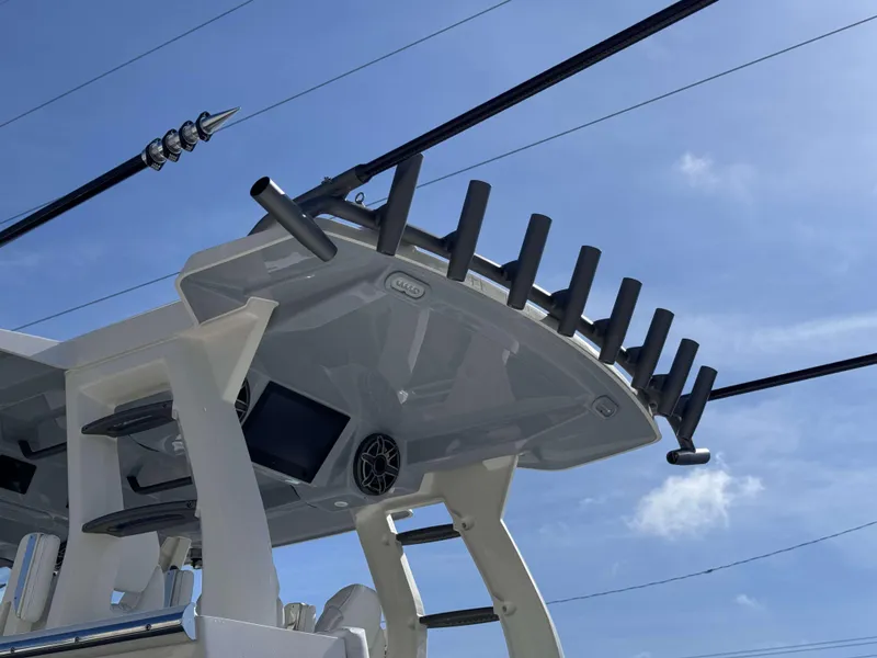 Slide: The Image of 2024 Solace 37 CS boat with rod holders and electronics under a clear blue sky. - 39