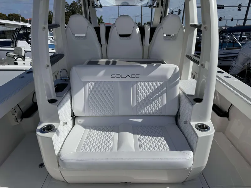 Slide: The Image of 2024 Solace 37 CS boat interior with white cushioned seating. - 4