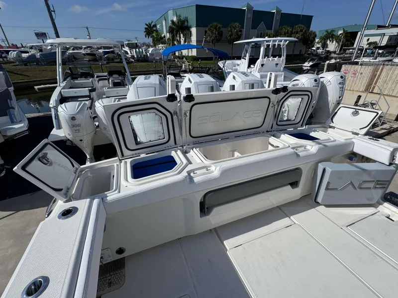 Slide: The Image of 2024 Solace 37 CS boat with open storage compartments and powerful outboard engines. - 40