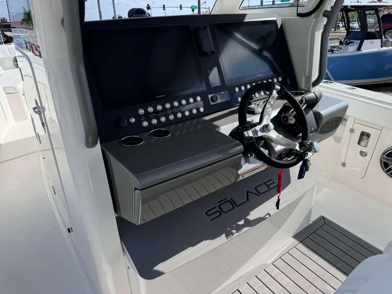 Slide: The Image of 2024 Solace 37 CS boat helm with dual displays and advanced controls. - 7