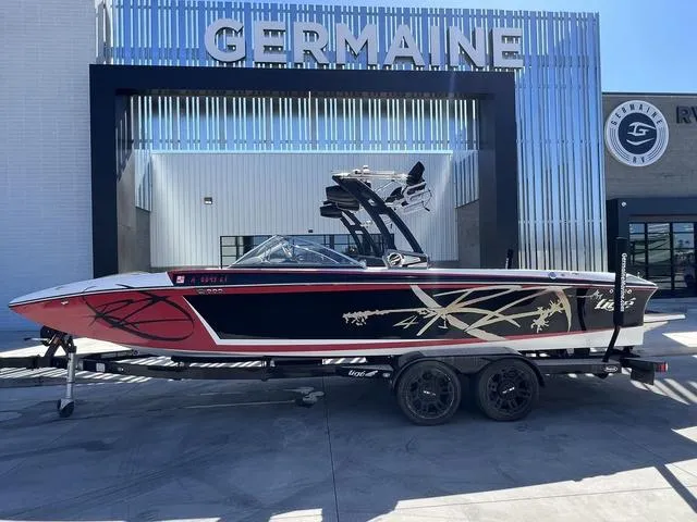 Slide: The Image of 2014 Tigé RZ4 boat on trailer at Germaine dealership. - 1