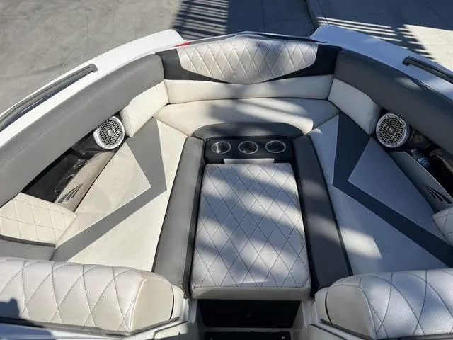 Slide: The Image of 2014 Tigé RZ4 boat interior with diamond-stitched seating and built-in cup holders. - 12