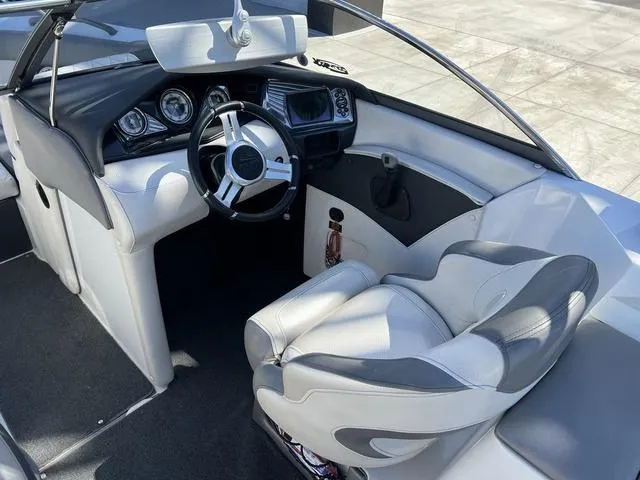 Slide: The Image of 2014 Tigé RZ4 boat interior, featuring a sleek dashboard and comfortable seating. - 13