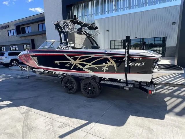 Slide: The Image of 2014 Tigé RZ4 boat on a trailer, black with red and white accents. - 3