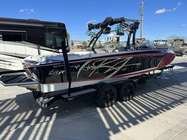 Slide: The Image of 2014 Tigé RZ4 boat on trailer, black and red with custom graphics. - 6