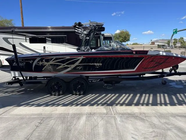 Slide: The Image of 2014 Tigé RZ4 boat on a trailer, parked outdoors. - 7