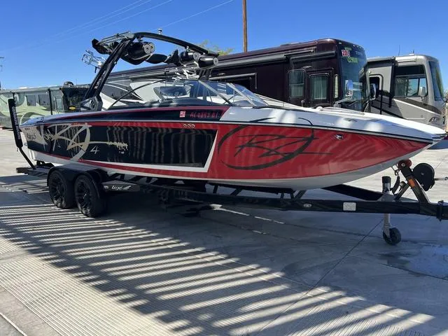 Slide: The Image of 2014 Tigé RZ4 boat on trailer, red and black design, parked outdoors. - 8