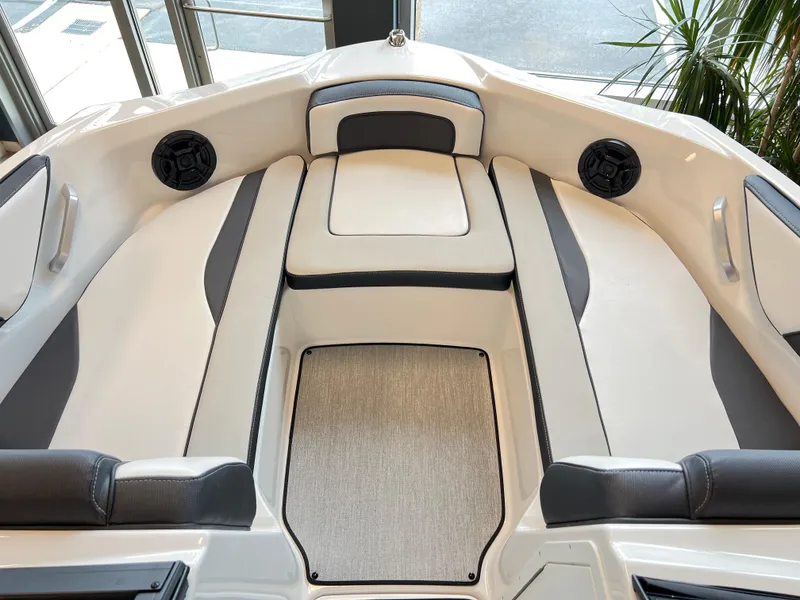 Slide: The Image of 2024 Yamaha Boats AR 195 interior with cushioned seating and built-in speakers. - 8