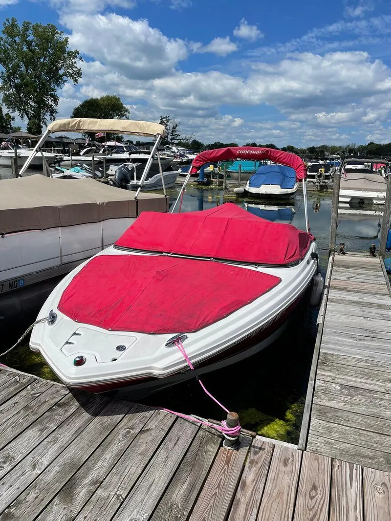 The Image of 2012 Chaparral 196 SSi boat docked with red cover on a sunny day. - 0