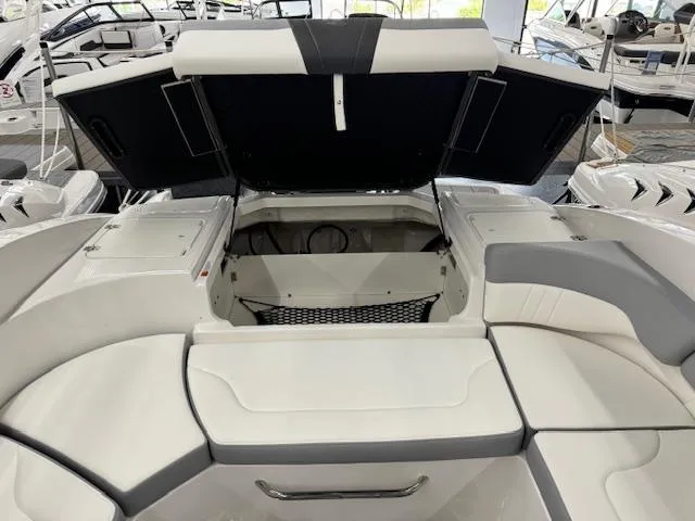 Slide: The Image of 2024 Chaparral 23 SSi OB boat interior with open storage compartments. - 16