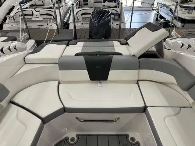 Slide: The Image of 2024 Chaparral 23 SSi OB boat interior with white and gray seating. - 19