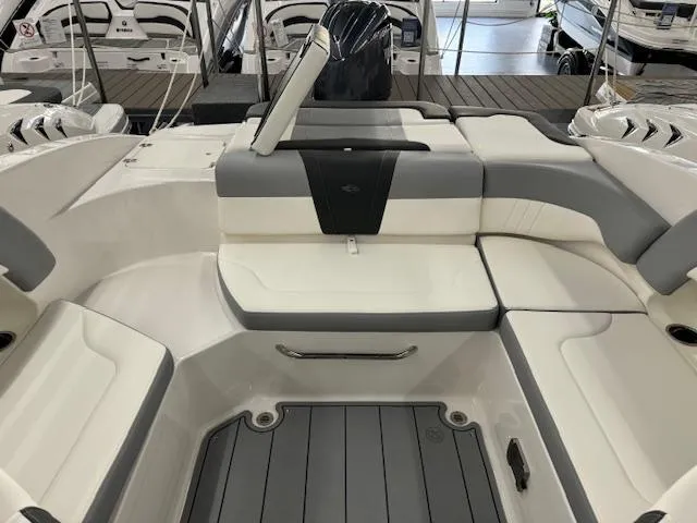 Slide: The Image of 2024 Chaparral 23 SSi OB boat interior with white and gray seating. - 21