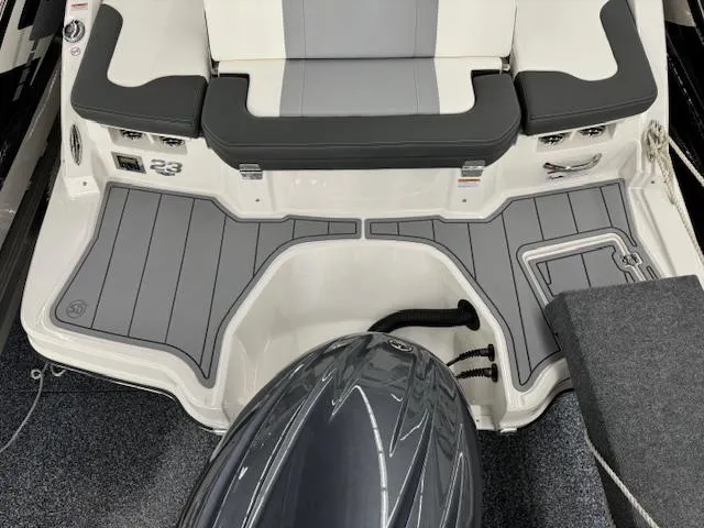 Slide: The Image of 2024 Chaparral 23 SSi OB boat stern with seating and outboard motor. - 24