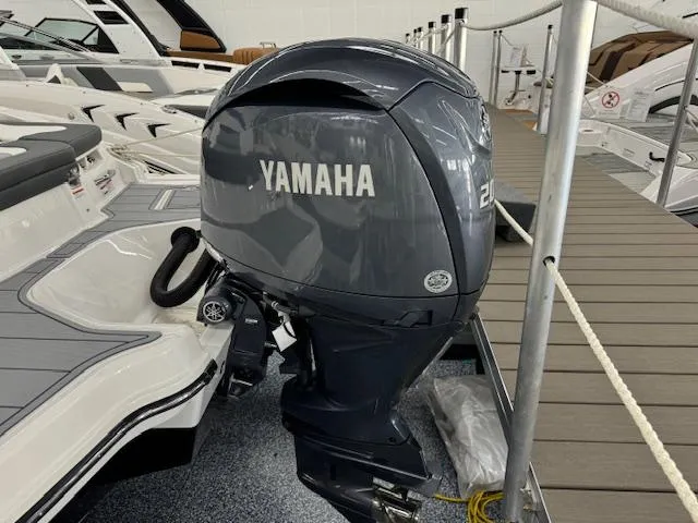 Slide: The Image of 2024 Chaparral 23 SSi OB with Yamaha outboard motor in a showroom. - 25