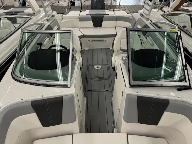 Slide: The Image of 2024 Chaparral 23 SSi OB boat interior with dual consoles and spacious seating. - 5