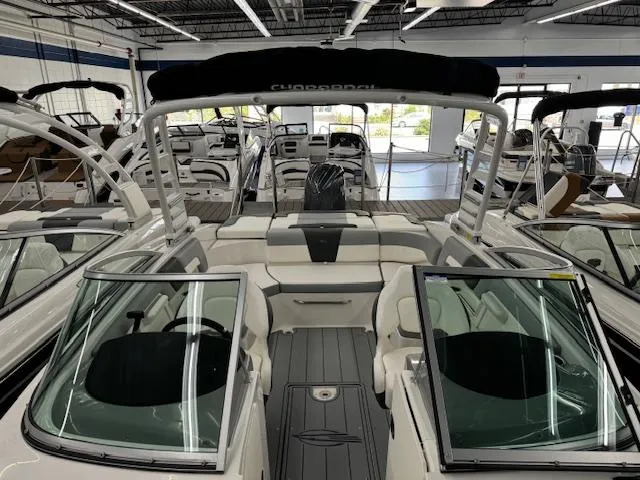 Slide: The Image of 2024 Chaparral 23 SSi OB boat interior with seating and windshield in showroom. - 6