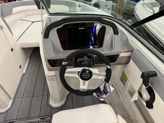 Slide: The Image of 2024 Chaparral 23 SSi OB boat cockpit with steering wheel and dashboard. - 8